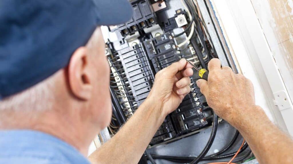 Home ac repair; Technician fixing breakers