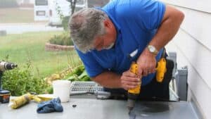 ac technician repairing outdoor ac unit